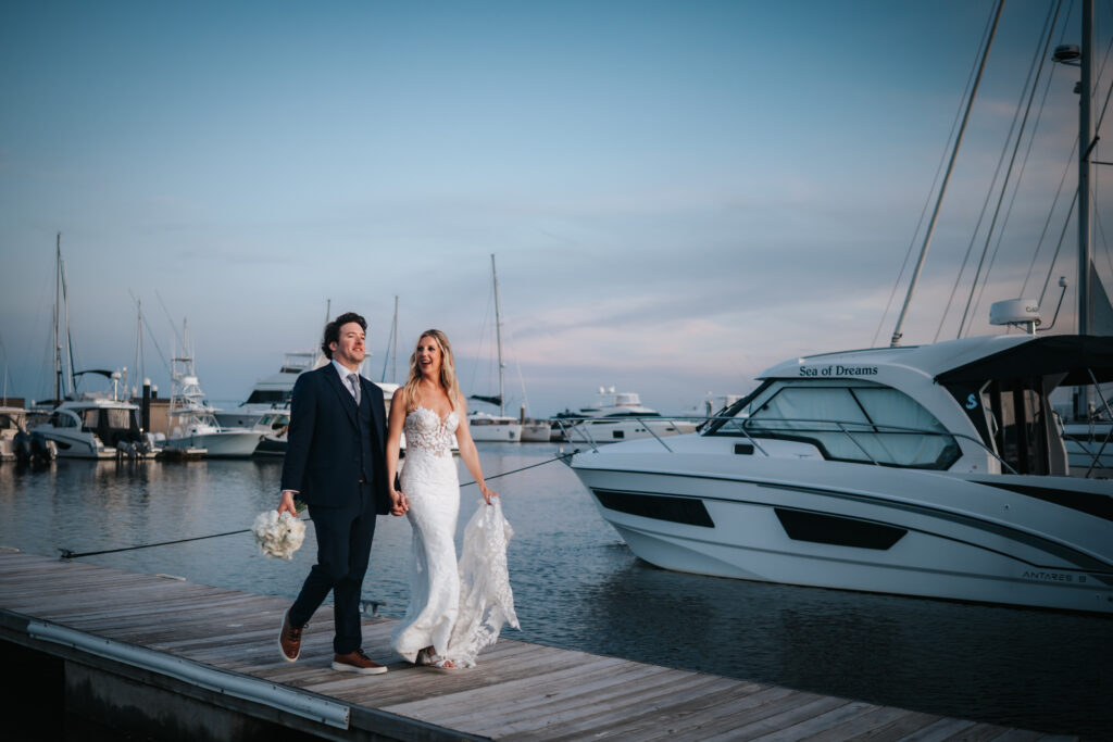 bride and groom walking in the marina at the rice mill