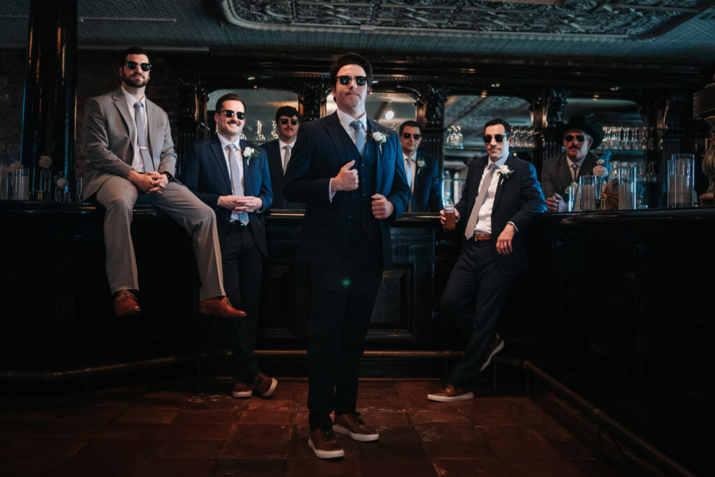 moody groomsmen portrait at the bar at the historic rice mill in charleston sc