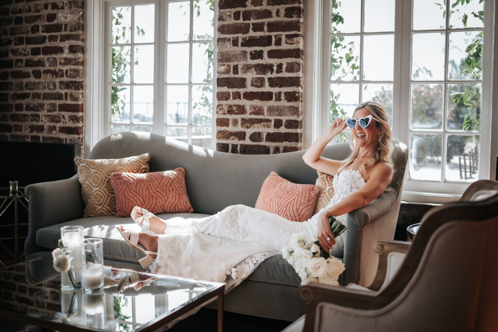 bride in a lounge area by the french eclectic at her historic rice mill wedding day