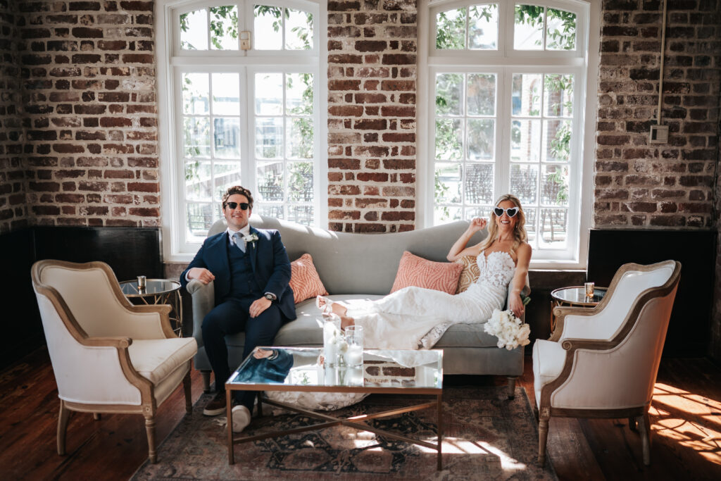 bride iand groom in sunglasses in lounge area by french eclectic