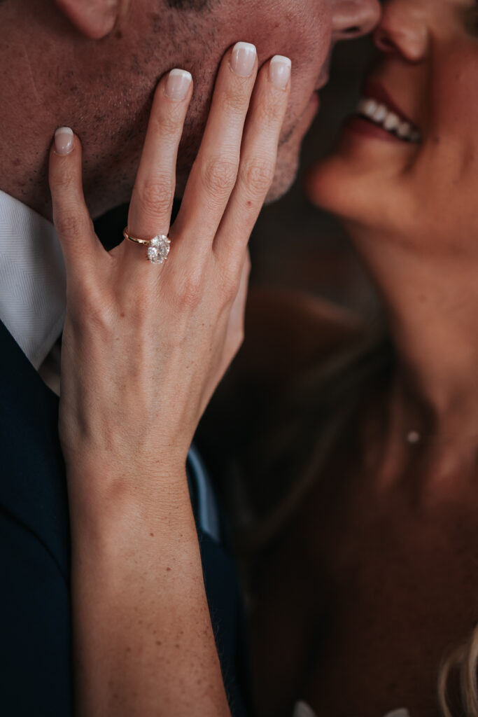 close up diamond ring shot of the bride and groom