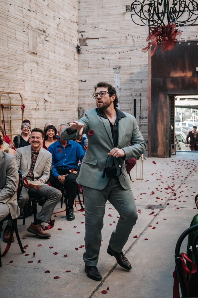 Flower dudes walking down the aisle with flower petals