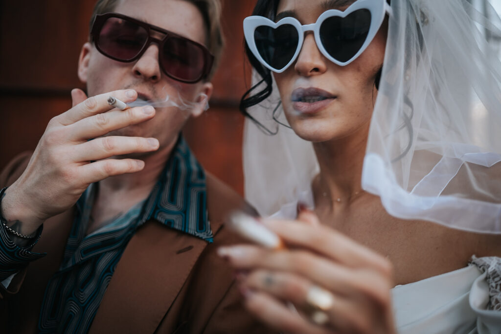 Rachel smoking beside Devin’s motorcycle after the ceremony