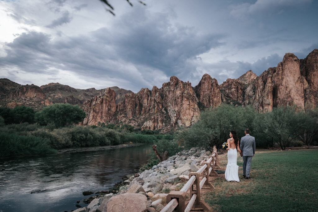 Wedding portraits beneath storm clouds at Saguaro Lake Ranch